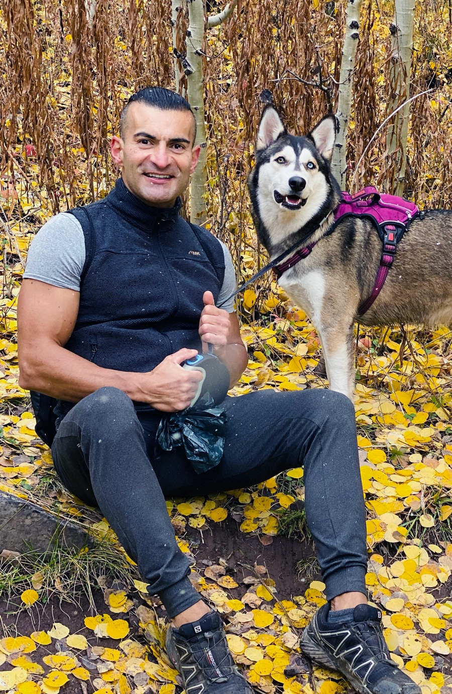 Dr. Cassio Castro with his husky dog in a fall forest