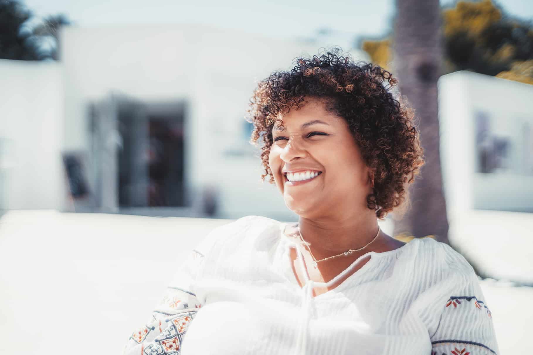 woman smiling during emergency dental appointment at odonto dental