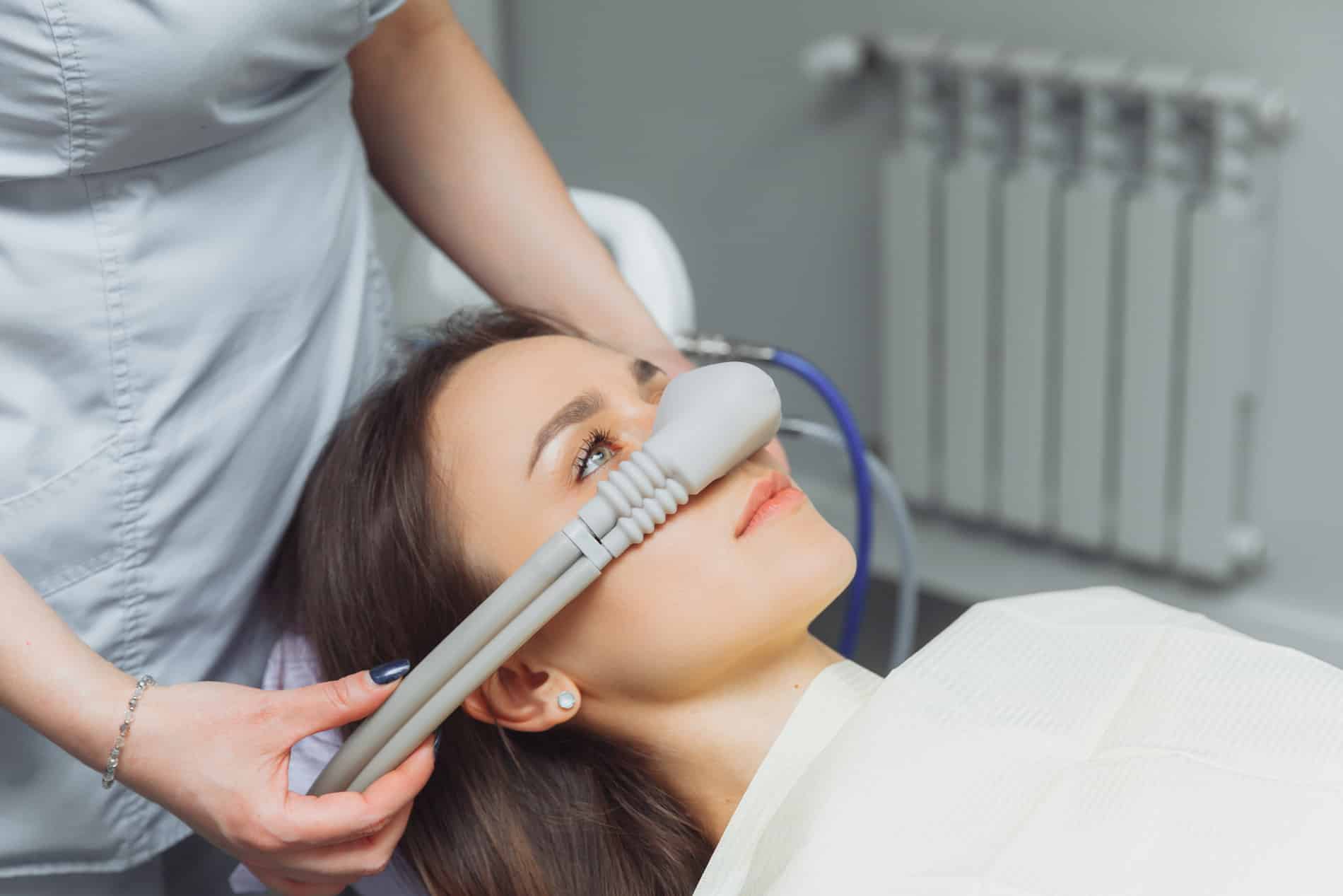 Woman being put under notrous oxide sedation dentistry with Dr. Castro in Aurora CO