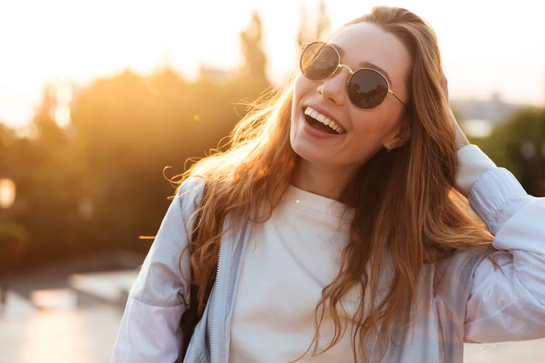 Woman enjoying the sun after a dental extraction in Aurora CO