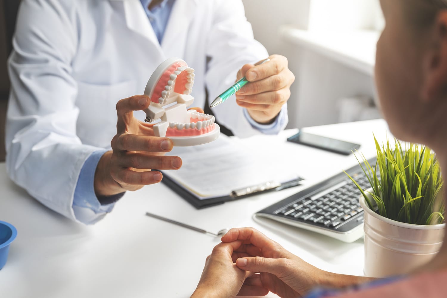 General dentist talks to patient in Aurora CO